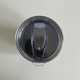 Clear plastic lid with a black interior on a light gray background