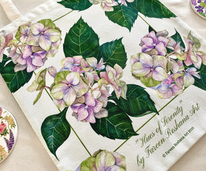 Close-up of Hues of Serenity tote bag featuring soft blue and purple watercolour hydrangeas printed on cotton canvas.