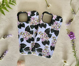Two iPhones in floral cases side by side, showcasing the artistic hydrangea design.