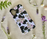 Angled view of the floral iPhone case showing sleek matte finish and soft hydrangea artwork.