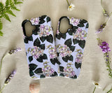 Two iPhones in floral cases side by side, showcasing the artistic hydrangea design.