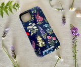 Angled view of wildflower iPhone case showing raised edge for camera protection and glossy finish