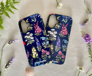 Two iPhones in floral cases side by side, showcasing the artistic wildflower design