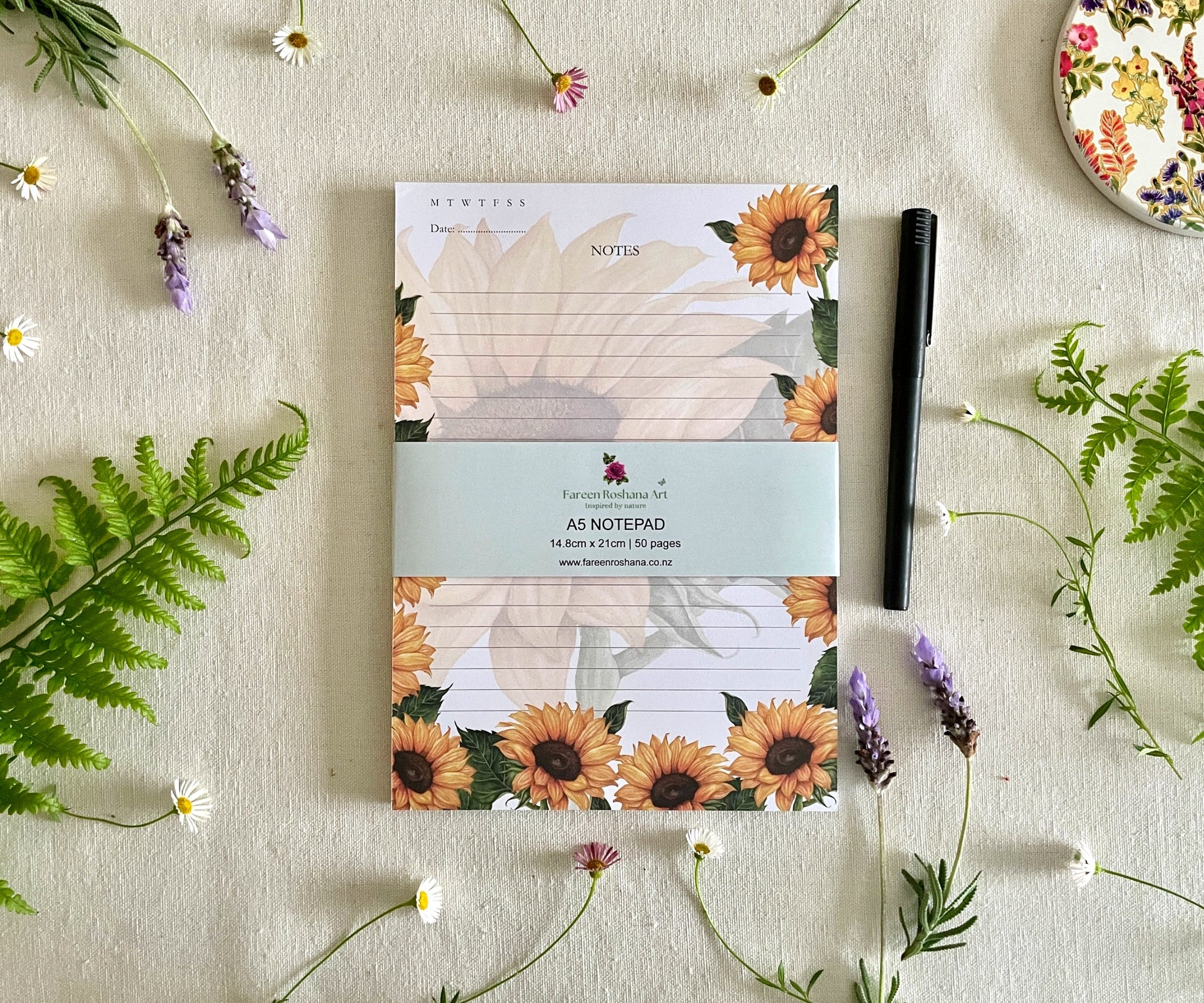 Front view of Heart of Sunshine sunflower notepad with bellyband