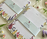 Two Petals of the Wild notepads with bellybands close-up