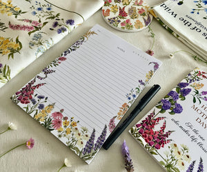 Petals of the Wild notepad shown with pen, no bellyband